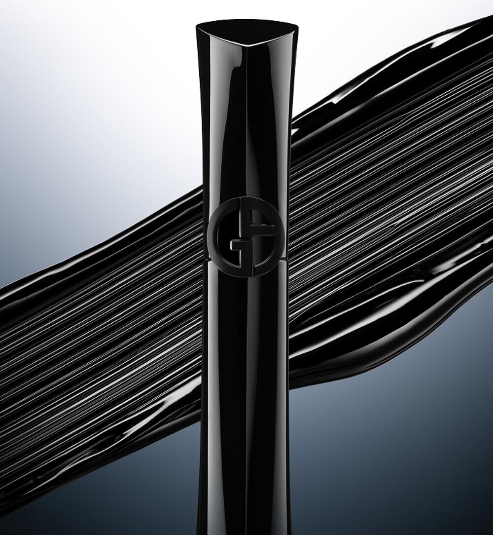 Giorgio Armani Vertigo Drama mascara in sleek black packaging, shown with its curved brush on a grey gradient background.
