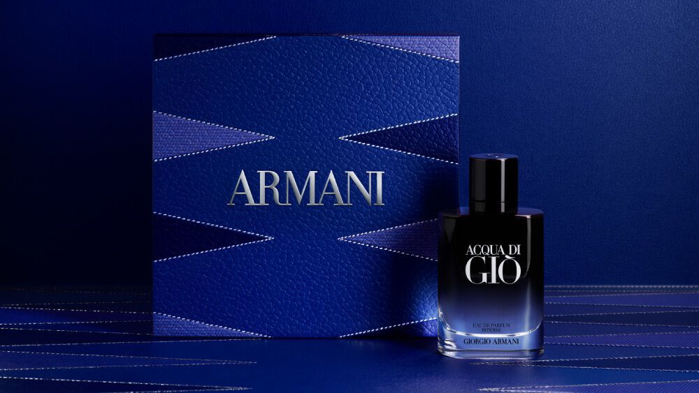 Armani ACQUA DI GIO EAU DE PARFUM INTENSE bottle displayed in front of a luxurious blue gift box with geometric patterns, emphasizing the brand’s elegance and premium gifting experience.