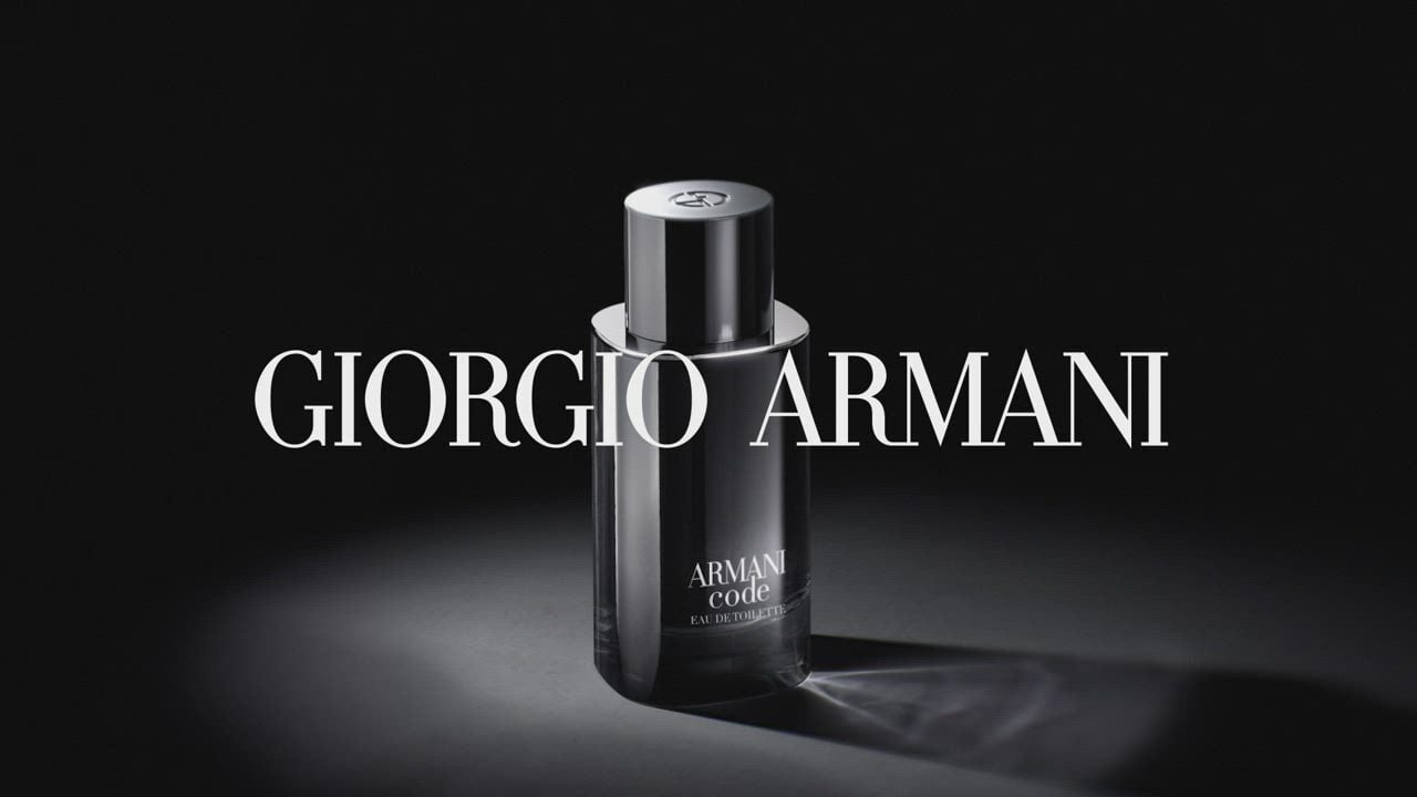 A sleek black bottle of Giorgio Armani Code fragrance, elegantly lit against a dark background.